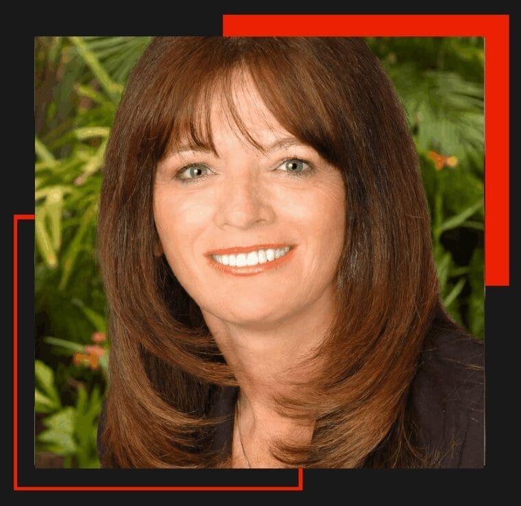 Smiling woman with brown hair, green background.